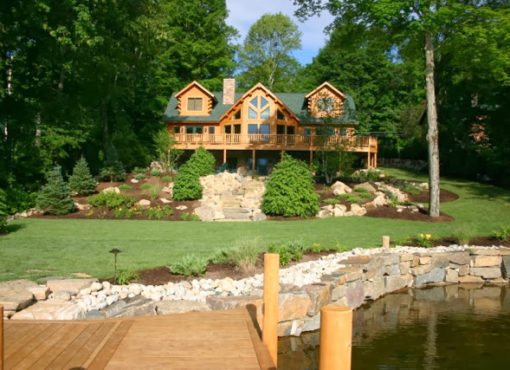 wood dock overlooking custom log home backyard