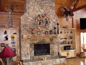 Custom woodworking adds style to this fireplace mantle in a Katahin Cedar Log Home.