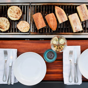 Veggis or meats, social grilling tables offer guests flexibility when entertaining at your Katahdin Cedar Log Home