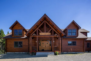 Whimsical carved otters welcome the entrance to Katahdin Cedar Log Home